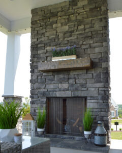 Dark grey Veneer stone fireplace with mantel